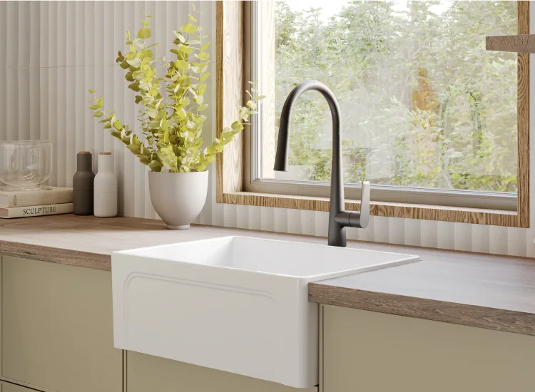 Creavit Esse ceramic kitchen sink beneath a window with a black faucet
